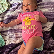 Hayvin joined the competition — help win amazing prizes! baby, infant, onesie, pink_clothing, giraffe_print, blanket, purple, white, smiling, lying_down, diaper, cute, playful, child, face, hand, foot, person, soft_texture, happy