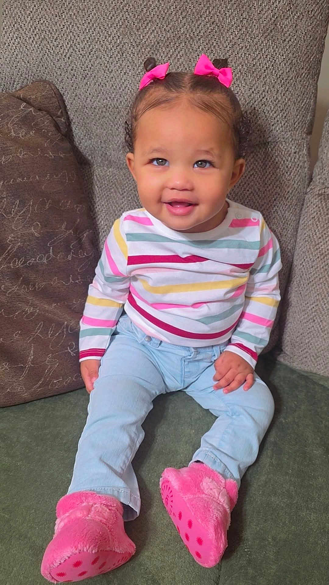 Kaliah joined the competition — help win amazing prizes! toddler, child, smiling, pink_bows, striped_shirt, light_blue_jeans, pink_slippers, sitting, couch, happy, indoors, cute, portrait, young_child, fashion, cozy, face, hair, feet, playful