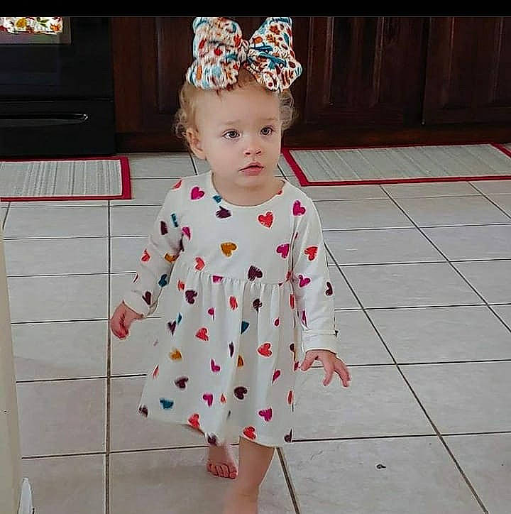 Roselina joined the competition — help win amazing prizes! baby, baby_toddler_clothing, clothing, costume_accessory, day_dress, display_device, foot, hair_accessory, headband, headpiece, nightwear, one_piece_garment, pattern, person, pink, polka_dot, sleeve, television, television_set, toddler