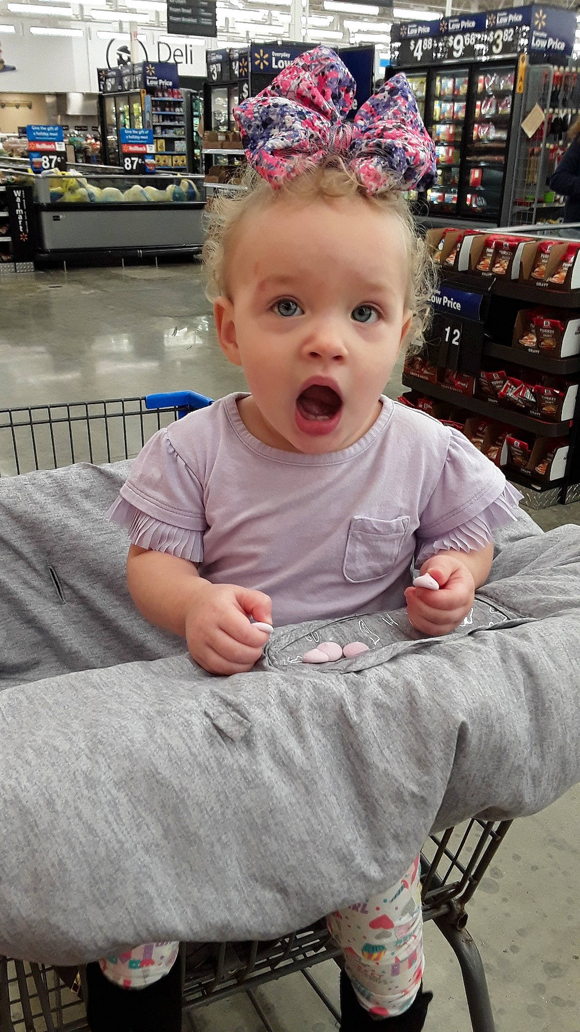 Roselina is registered to the contest to win money with this photo: baby, baby_products, baby_toddler_clothing, bench, child, costume_accessory, hair_accessory, headband, headpiece, party_hat, party_supply, person, pink, shelf, shelving, sock, surprise, toddler