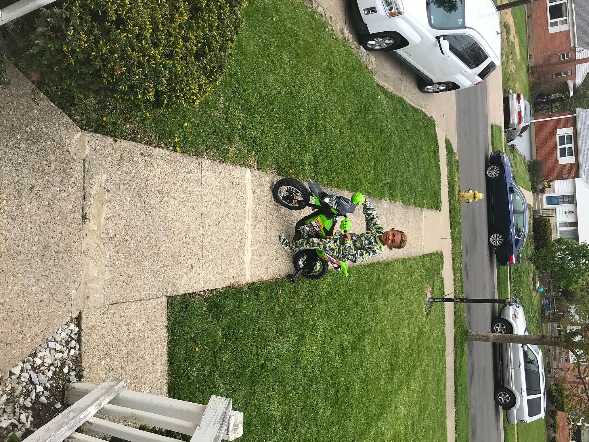 Demetrius joined the competition — help win amazing prizes! asphalt, automotive_exterior, automotive_tire, car, grass, green, infrastructure, line, motor_vehicle, motorcycle, person, plant, public_space, road_surface, sidewalk, tire, tree, urban_design, vehicle, wall