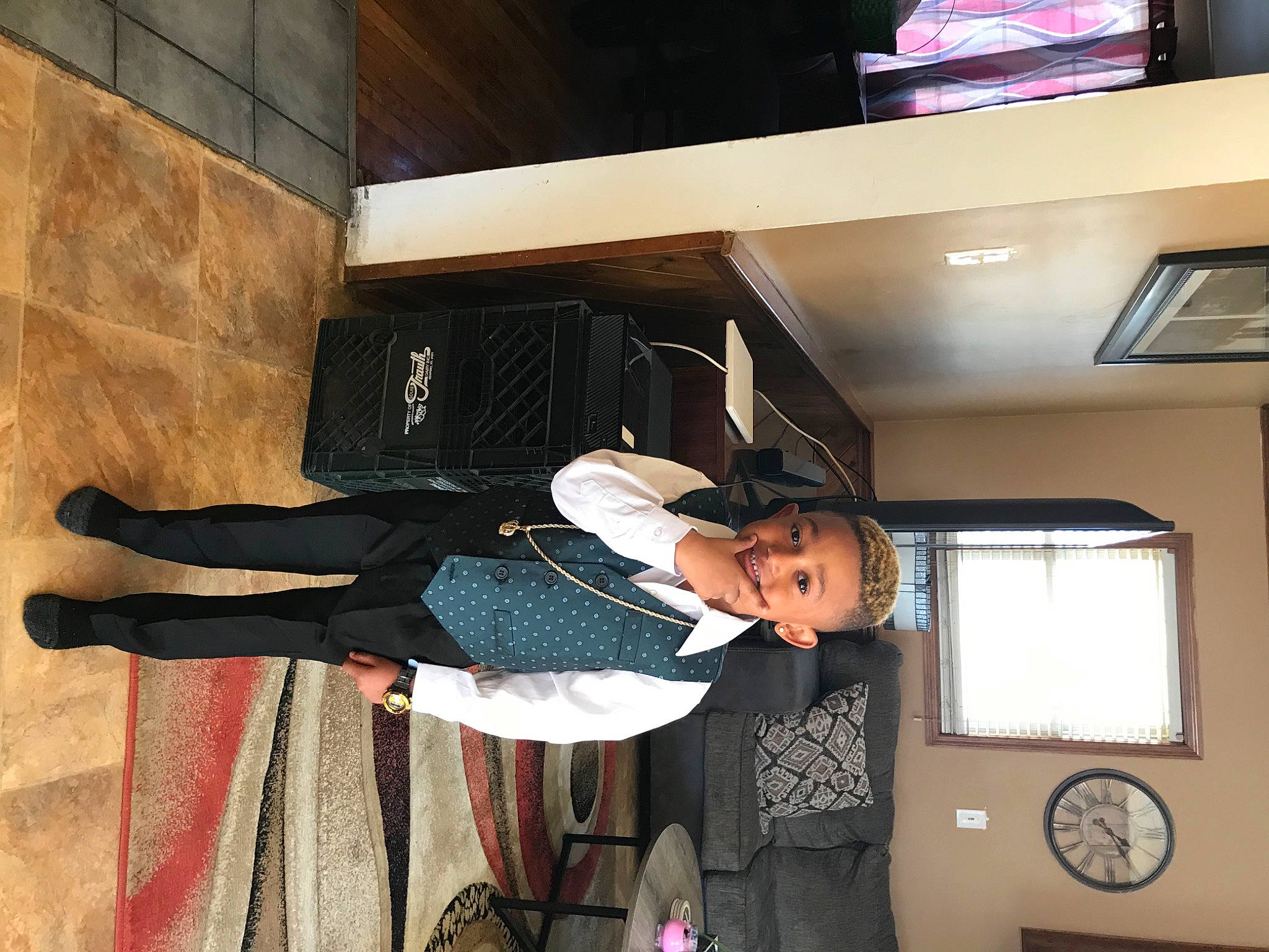 Demetrius is registered to the contest to win money with this photo: ceiling, clock, comfort, display_device, flooring, hardwood, hat, joy, led_backlit_lcd_display, person, room, television, walking_shoe