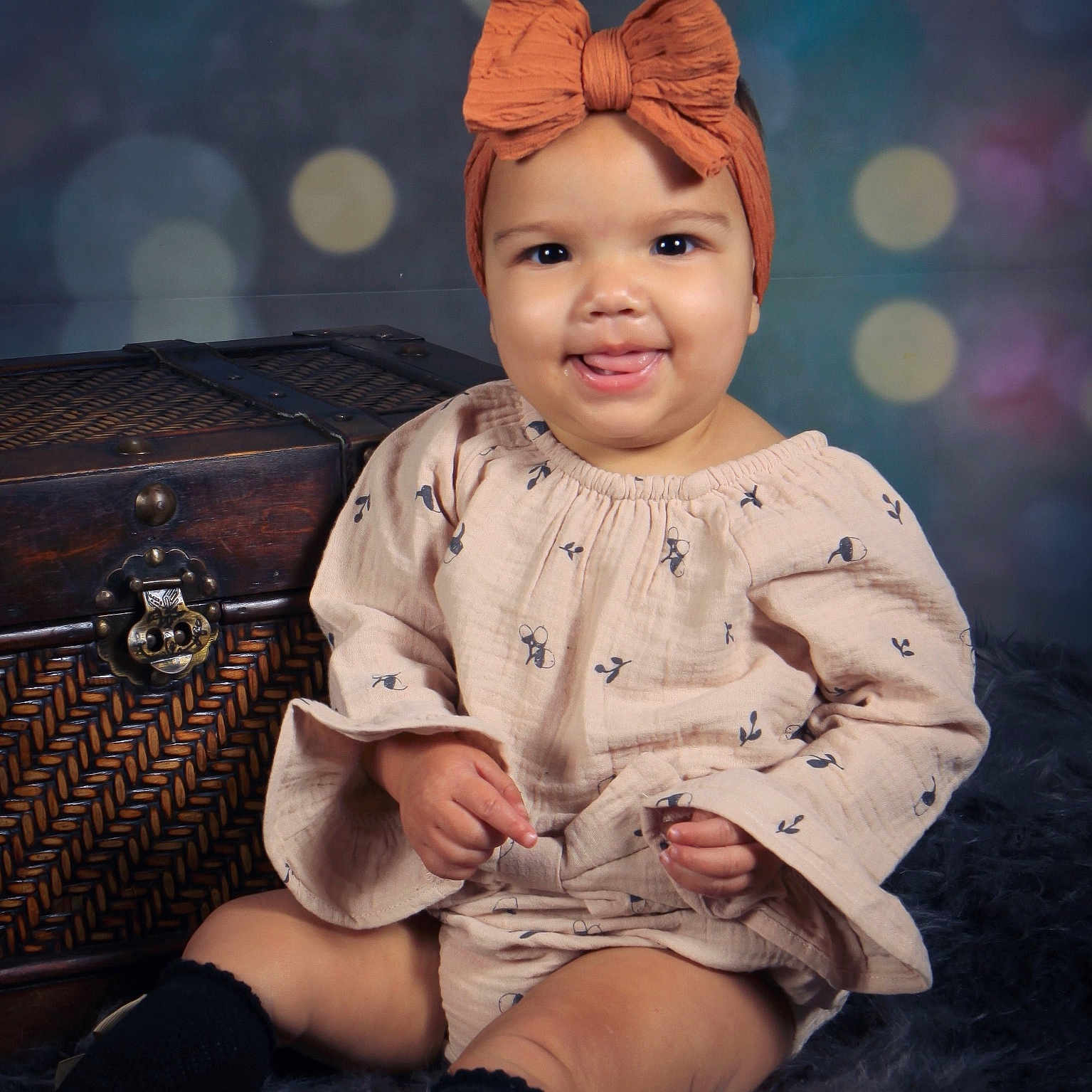 Sailer is registered to the contest to win money with this photo: accessories, baby, bodypart, cap, clothing, dress, face, finger, hand, happy, hardwood, hat, head, person, photography, portrait, sitting, smile, turban, wood