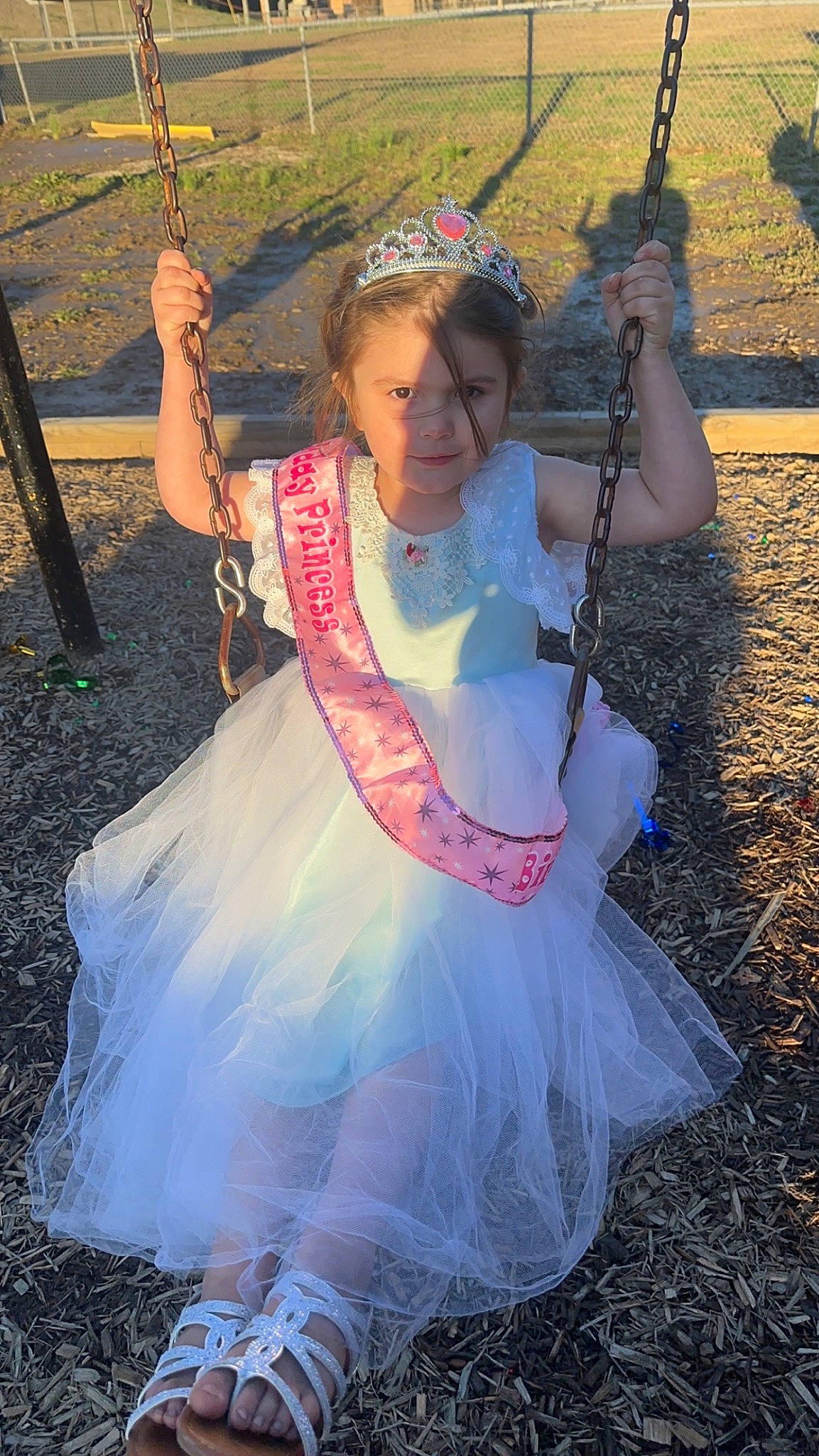 Paislee is registered to the contest to win money with this photo: child, cool, dress, event, fashion_accessory, flash_photography, fun, grass, happy, headpiece, jewellery, leisure, magenta, necklace, outdoor_play_equipment, people_in_nature, person, photograph, pink, playground