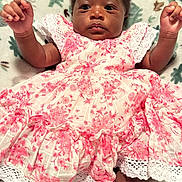 Liz is registered to the contest to win money with this photo: baby, child, infant, dress, pink, white, floral, blanket, arms, cute, portrait, lying_down, soft, patterned_blanket, indoors, person, young_child, happy, clothing, sock