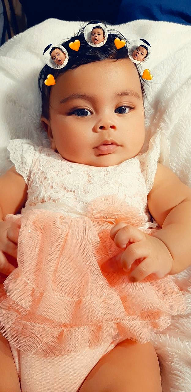 Aleyna is registered to the contest to win money with this photo: baby, cheek, child, doll, dress, eye, face, forehead, hair_accessory, head, headband, headgear, headpiece, iris, lip, peach, person, pink, skin, toddler