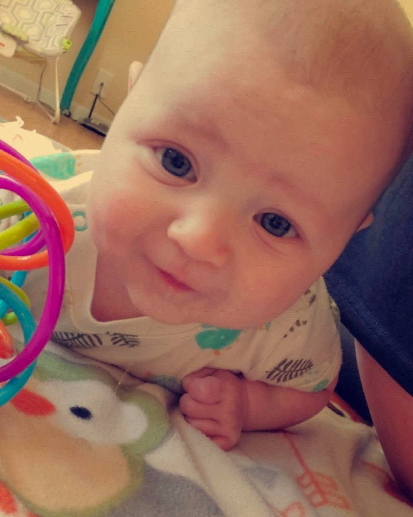 Brixton is registered to the contest to win money with this photo: baby, baby_playing_with_toys, baby_toddler_clothing, cheek, chin, ear, eyebrow, facial_expression, finger, hairstyle, happy, head, iris, lip, mouth, nose, person, photograph, product, skin