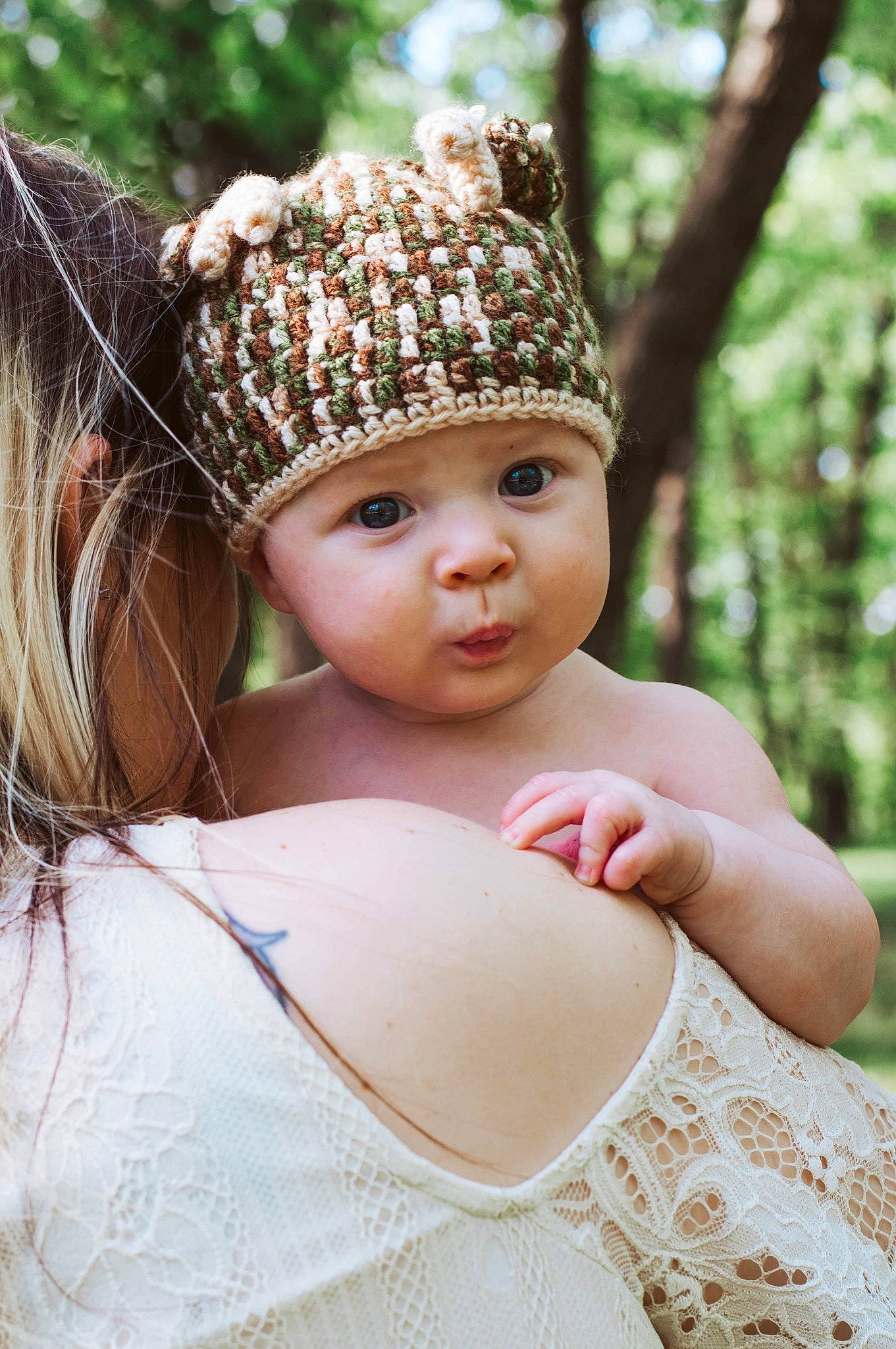 Brixton is registered to the contest to win money with this photo: baby, cap, child, dress, eye, flash_photography, grass, hair, happy, head, headband, headpiece, headwear, knit_cap, pattern, people_in_nature, person, skin, toddler, tree