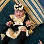 Elda-Rose joined the competition — help win amazing prizes! baby, black_dress, bow, child, couch, curious, cute, expression, furniture, headband, indoor, infant, lace, pacifier, person, portrait, sitting, sock, soft_lighting, striped_cushions