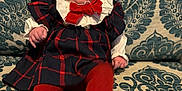 Elda-Rose is registered to the contest to win money with this photo: baby, child, clothing, couch, cute, decor, fabric, happy, headband, indoor, infant, patterned_couch, person, plaid_dress, portrait, red_bow, red_tights, sitting, smiling, tongue_out