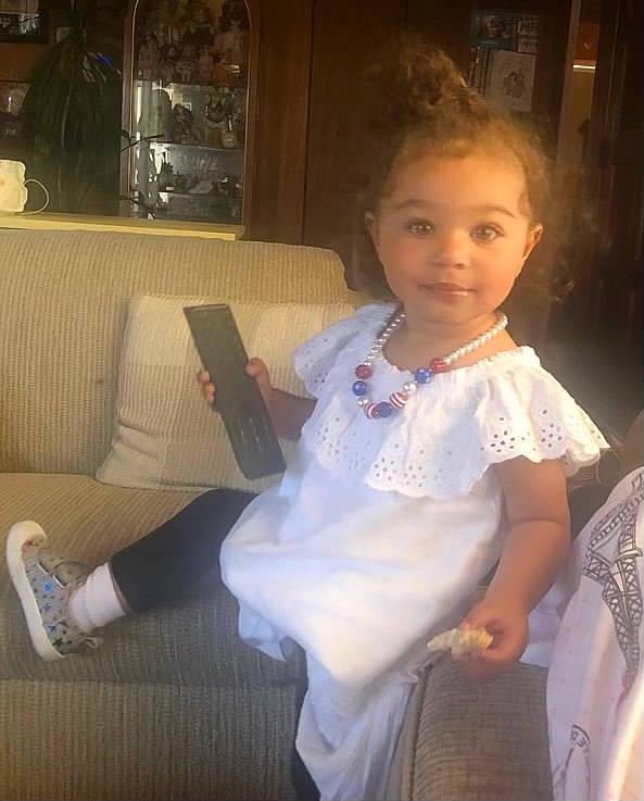 Kalisa Roberts is registered to the contest to win money with this photo: baby_toddler_clothing, cheek, child, dress, event, fashion_design, flash_photography, flooring, formal_wear, fun, happy, human_leg, iris, joy, lap, person, room, shoulder, sitting, skin