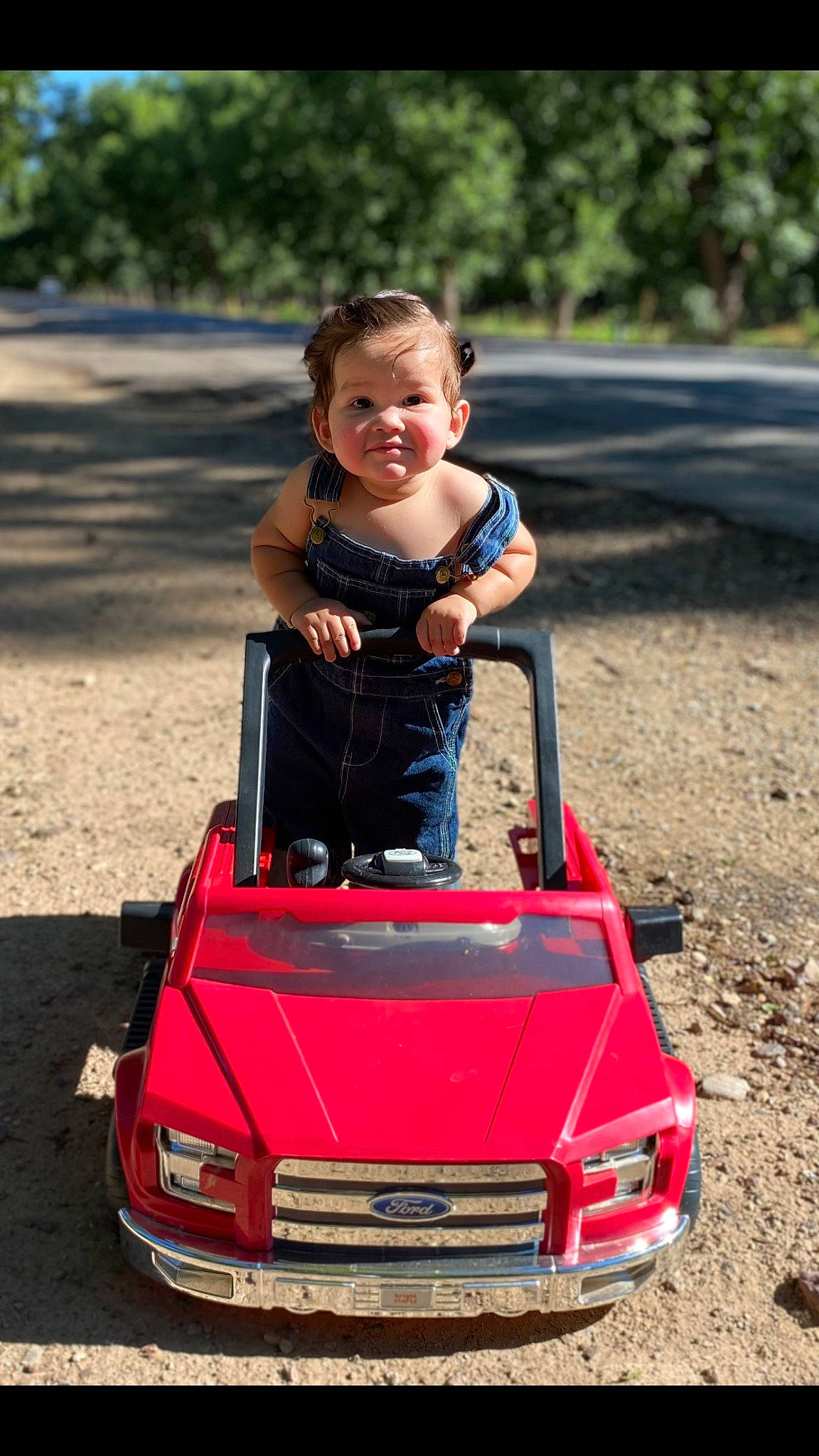 Cyrus is registered to the contest to win money with this photo: automotive_design, automotive_exterior, automotive_lighting, automotive_tire, bumper, car, face, hair, happy, hood, motor_vehicle, person, photograph, red, smile, tire, toddler, tree, vehicle, vehicle_registration_plate