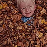 child, smiling, blonde_hair, autumn_leaves, fall, outdoor, nature, play, happy, face, head, seasonal, leaves, childhood, joy, portrait, casual, fun, person, young