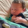 newborn, baby, sleeping, blanket, pacifier, infant, hands, cozy, soft_light, portrait, cute, child, resting, indoors, closeup, peaceful, toddler, curly_hair, face, sleep