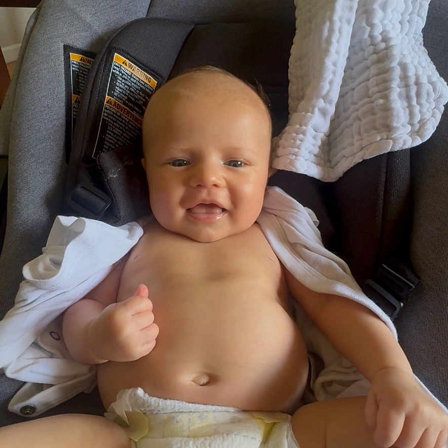 Sunara joined the competition — help win amazing prizes! baby, bottle, car_seat, child, clothing, couch, diaper, face, furniture, happy, head, home, indoor, infant, person, seat_belt, skin, smiling, socks, white_blanket