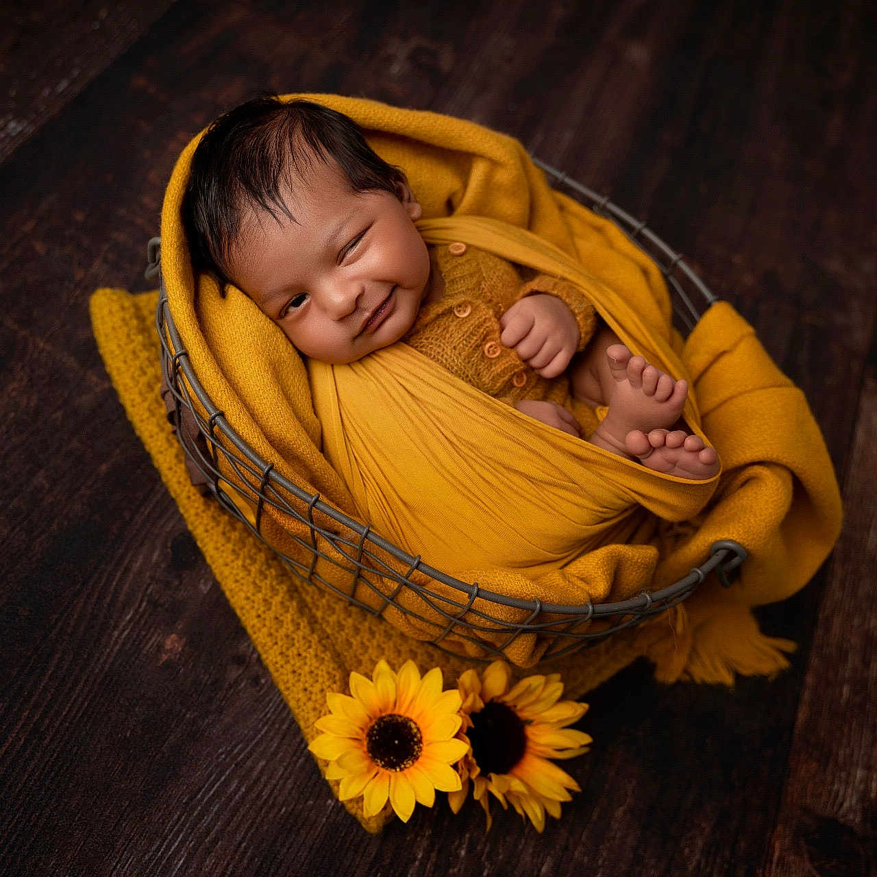 Tanush joined the competition — help win amazing prizes! baby, basket, blanket, child, cozy, cute, feet, hand, indoor, infant, knitwear, newborn, portrait, smiling, sunflowers, warm_colors, winking, wooden_floor, wrapped, yellow