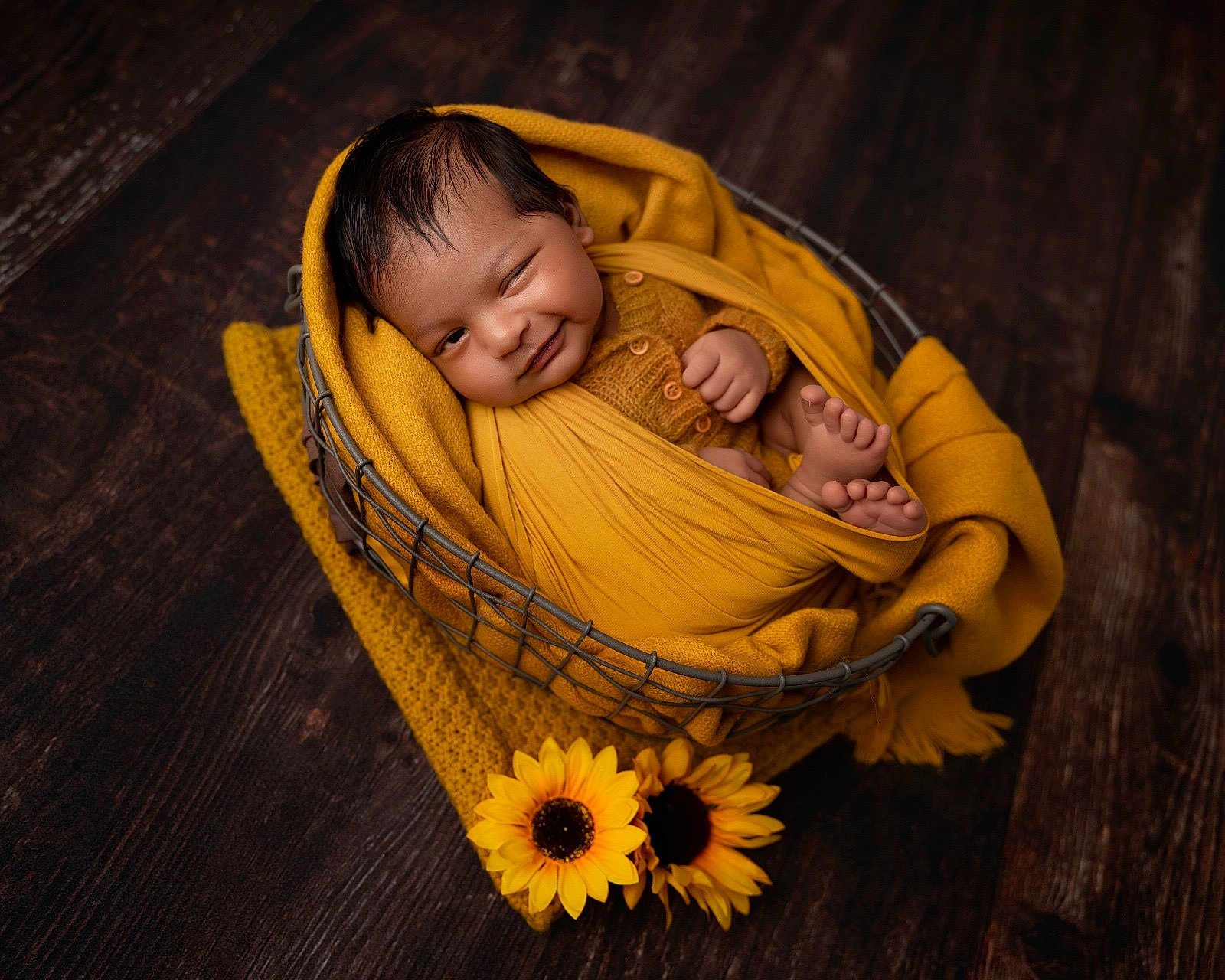 Tanush joined the competition — help win amazing prizes! baby, infant, newborn, wrapped, yellow, blanket, basket, wooden_floor, sunflowers, smiling, winking, cute, cozy, portrait, child, feet, hand, knitwear, indoor, warm_colors