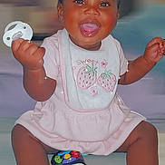 Kardiaye joined the competition — help win amazing prizes! baby, child, smiling, pacifier, bows, hair_accessories, pink_clothing, bib, toy_phone, sitting, happy, indoors, cute, infant, playful, portrait, sparkles, dark_skin, short_hair, cheerful