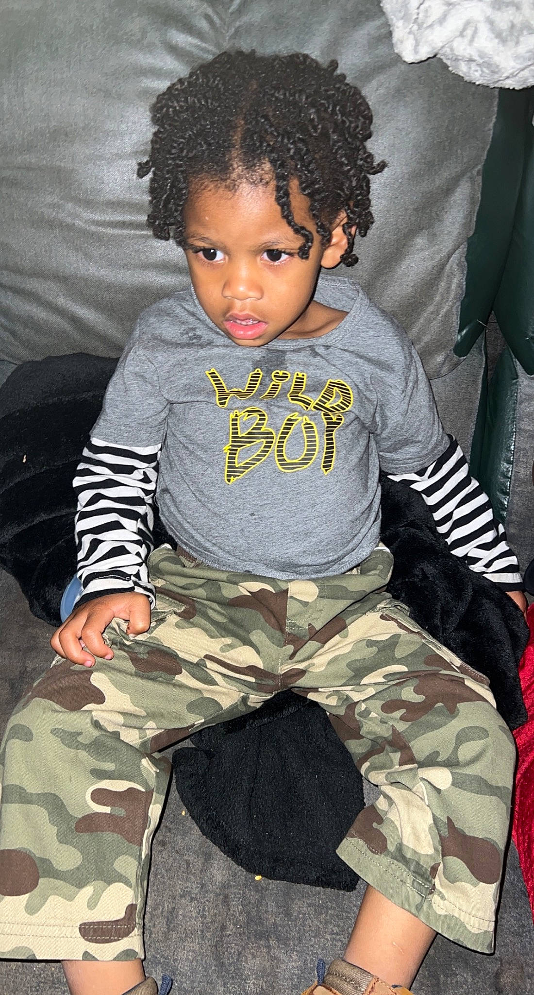 Cayden is registered to the contest to win money with this photo: afro, baby_toddler_clothing, beauty, black, camouflage, cheek, child, comfort, cool, fashion, head, joint, military_camouflage, neck, pattern, person, skin, sleeve, t_shirt, thigh