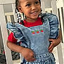 child, smiling, denim_overalls, red_shirt, braided_hair, beads, indoor, crib, bedroom, star_sticker, happy, cute, fashion, person, toddler, furniture, wall, clothing, portrait, young