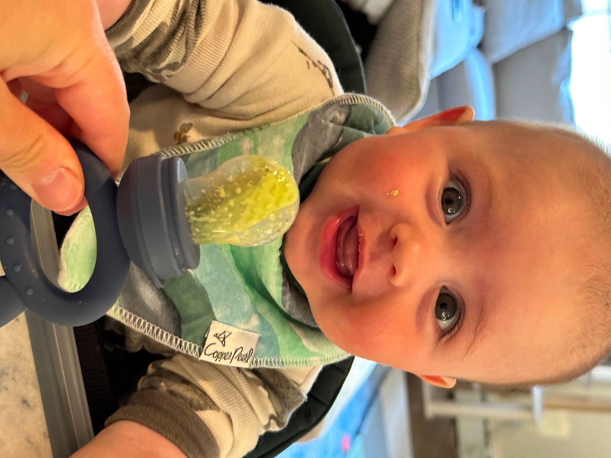 Atticus is registered to the contest to win money with this photo: baby, child, comfort_food, drinking, eating, finger, food, fun, happy, iris, joy, leisure, person, plant, recipe, smile, tableware, thumb, toddler, tree