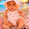 baby, child, infant, beach, ocean, sunset, palm_tree, sand, sunhat, pink_outfit, romper, sunglasses, blanket, seated, portrait, close_up, outdoor, tropical, sunlight, smiling