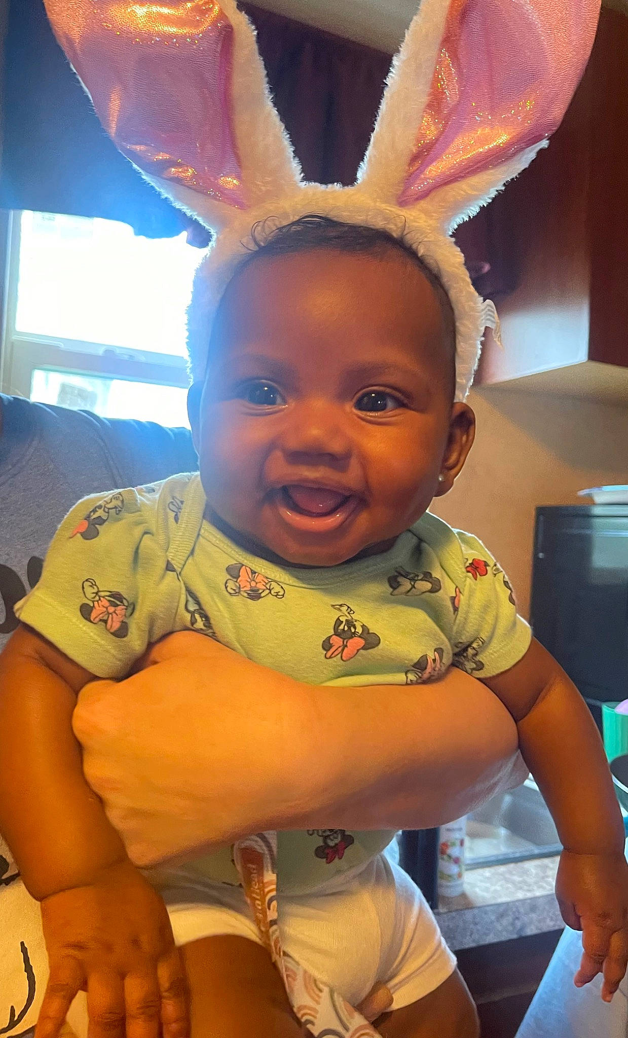 Kambriella is registered to the contest to win money with this photo: baby, child, ear, event, fun, gesture, happy, human_body, mouth, nose, organ, person, room, sitting, skin, smile, snapshot, t_shirt, thumb, toddler