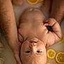 baby, infant, bath, milk_bath, citrus_slices, lemons, oranges, hands, skin, water, relaxation, closeup, portrait, cute, peaceful, soft_light, fresh, healthy, natural, parent