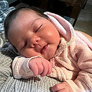 Ayla Alsadh joined the competition — help win amazing prizes! baby, sleeping, pink_hoodie, hand, face, infant, soft_texture, blanket, gray_blanket, closeup, cute, peaceful, resting, indoors, warm_clothing, portrait, child, newborn, cozy, relaxing