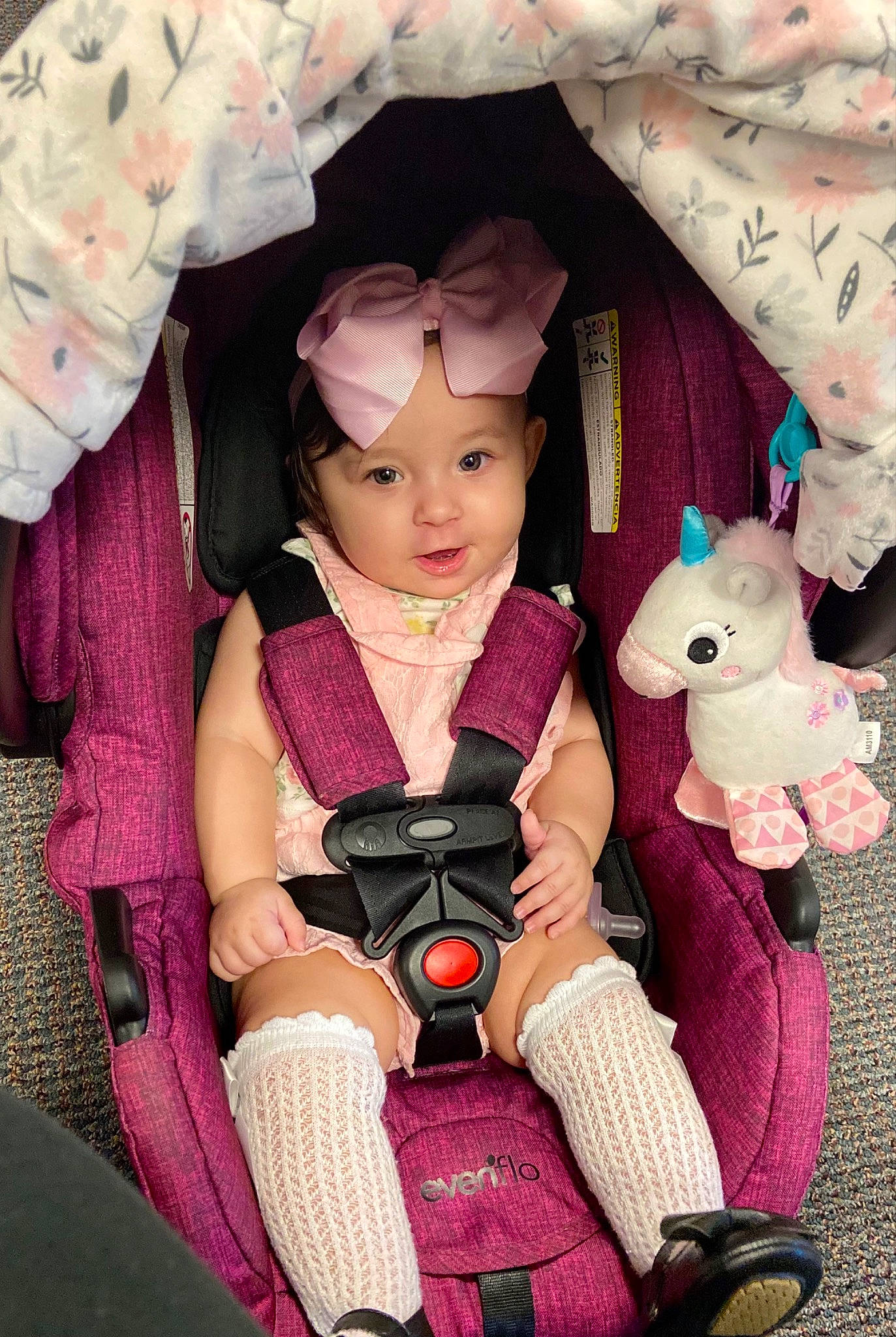 Bianca is registered to the contest to win money with this photo: baby_products, boot, carmine, child, costume, doll, event, fashion_design, fun, happy, headwear, lap, magenta, person, pink, product, purple, sitting, skin, smile
