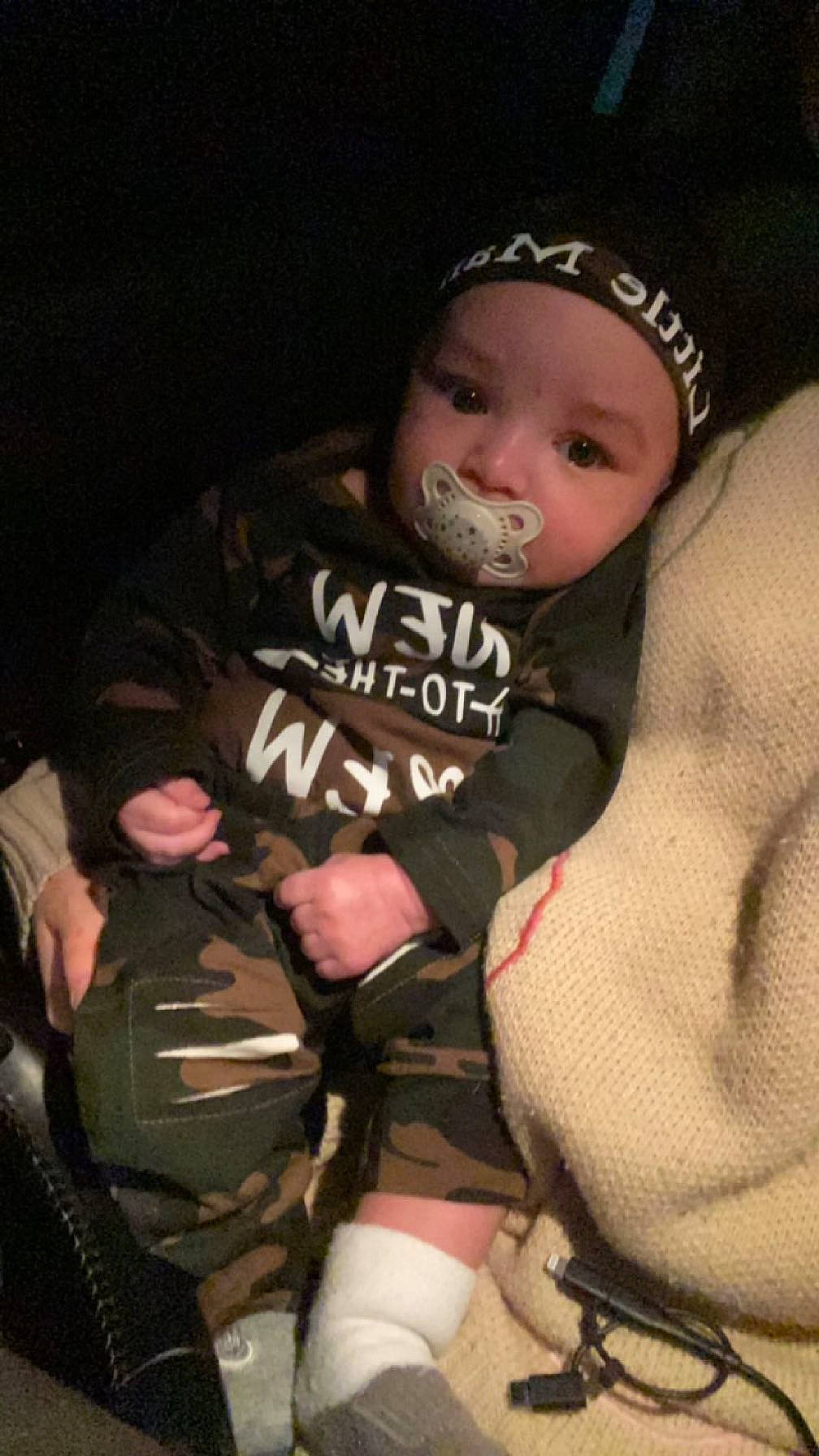 Adrian joined the competition — help win amazing prizes! baby, baby_products, baby_toddler_clothing, cap, comfort, finger, fun, headwear, human_leg, mammal, mouth, pattern, person, personal_protective_equipment, sitting, sleeve, sock, stocking, t_shirt, thigh