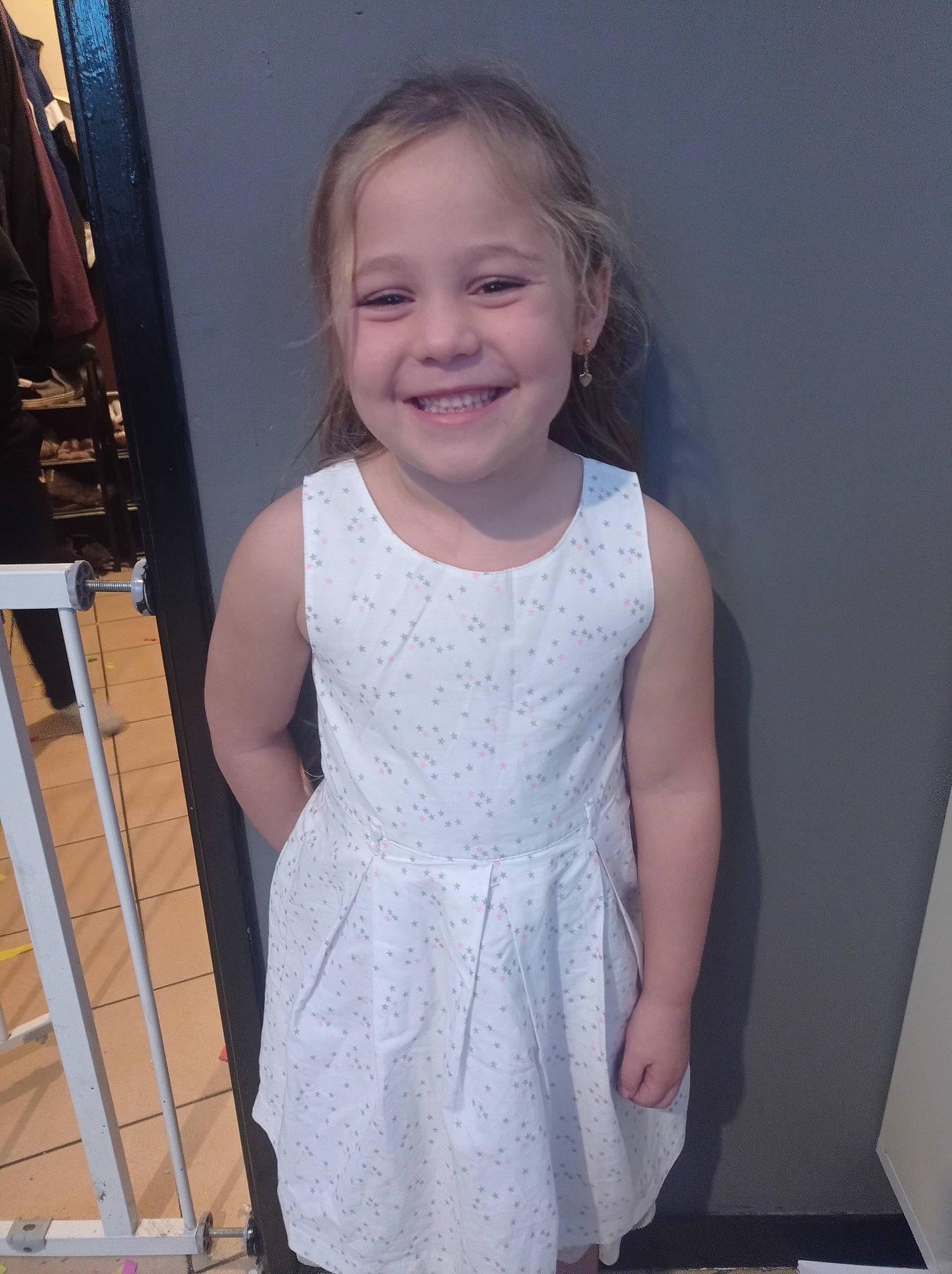 Celia participe au concours pour gagner de l'argent avec cette photo : baby_toddler_clothing, child, day_dress, dress, embellishment, flash_photography, happy, iris, joint, joy, long_hair, neck, one_piece_garment, pattern, person, shoulder, sleeve, smile, standing, toddler