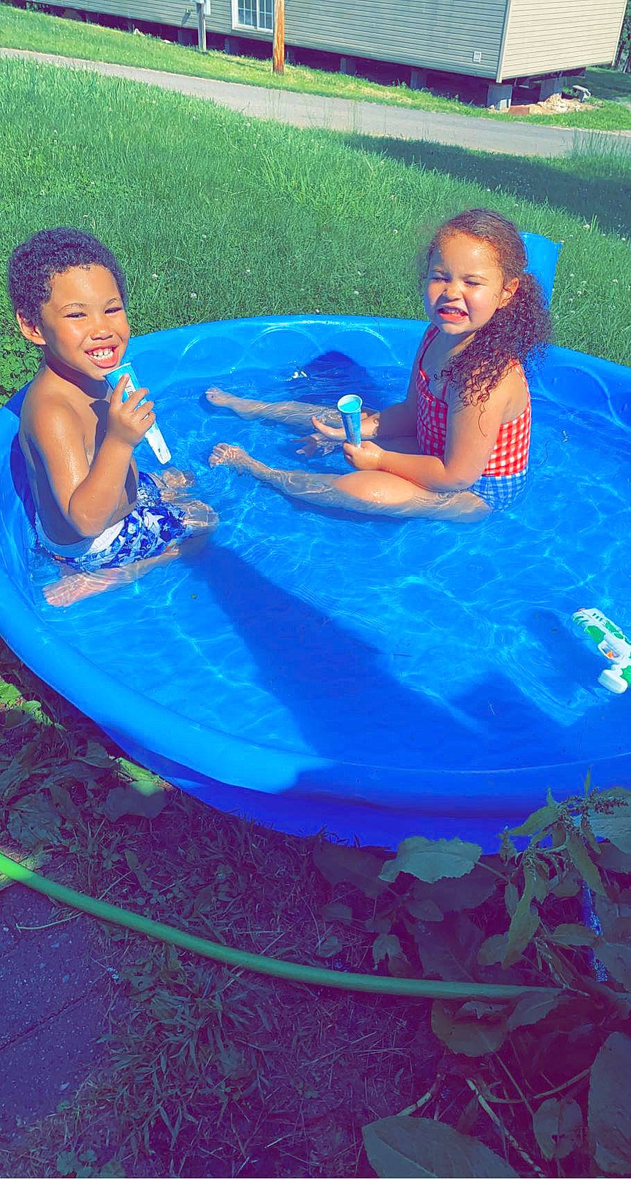 Meilani is registered to the contest to win money with this photo: aqua, azure, baby_toddler_clothing, blue, electric_blue, event, games, grass, happy, inflatable, joy, leisure, outdoor_recreation, people_in_nature, person, play, recreation, sharing, sitting, smile