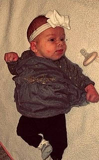 Charleigh is registered to the contest to win money with this photo: art, baby, baby_toddler_clothing, cap, cheek, child, eye, fur, headgear, headwear, iris, jacket, lip, organ, painting, pattern, person, sitting, sleeve, toddler