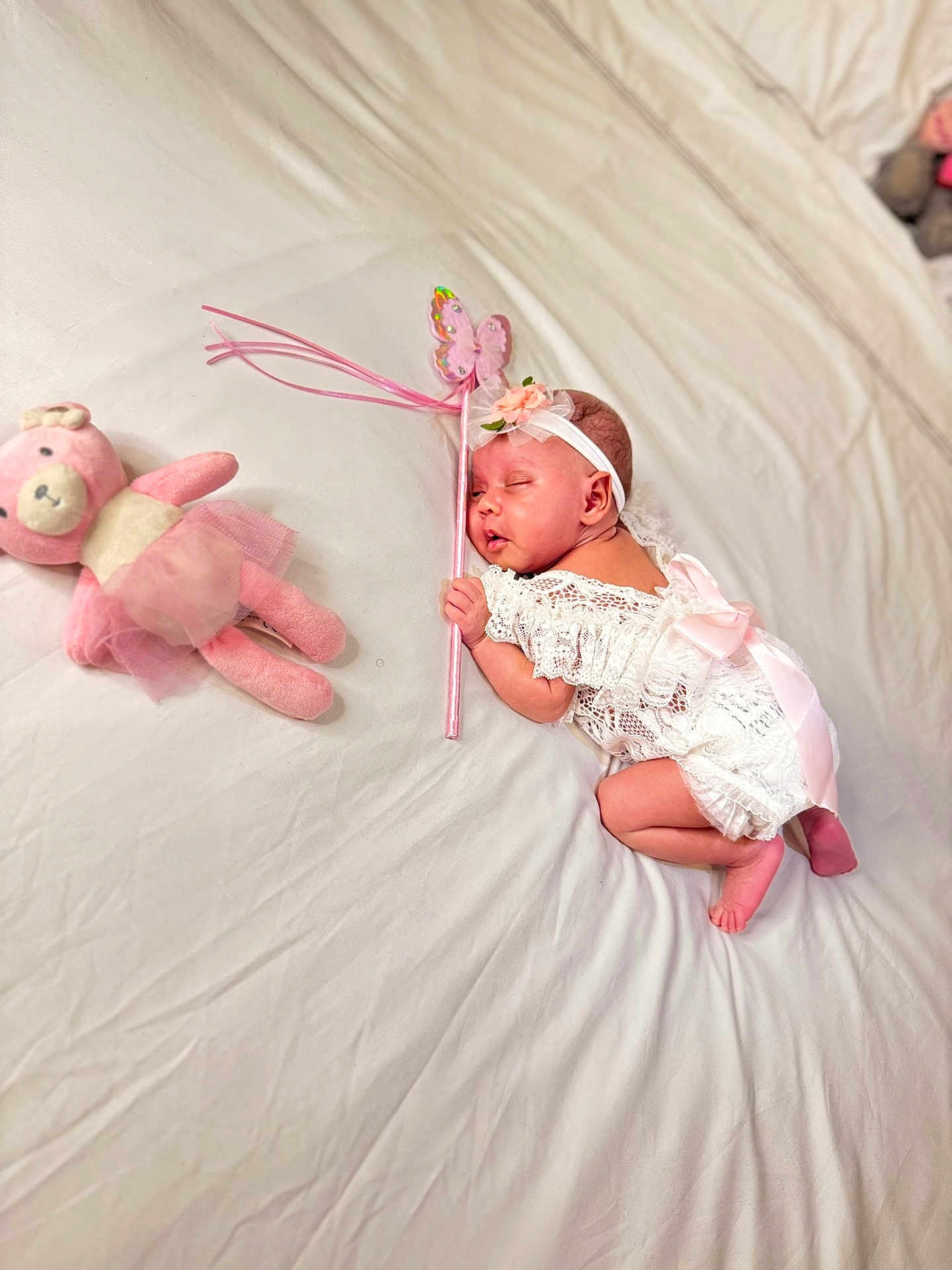 Skyler joined the competition — help win amazing prizes! adorable, baby, bed, butterfly_wand, child, cute, headband, indoors, infant, newborn, peaceful, pink_bow, pink_teddy_bear, portrait, resting, sleeping, soft_toy, tutu, white_bed_sheet, white_lace_outfit
