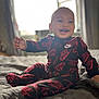 baby, smiling, child, nike, clothing, indoor, bed, blanket, happy, portrait, infant, cute, sitting, cozy, apparel, person, soft_light, window, home, young