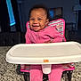 baby, child, cute, face, floor_lamp, footwear, furniture, granite_countertop, happy, high_chair, home, indoor, infant, person, pink_clothing, seat, smiling, table, television, window