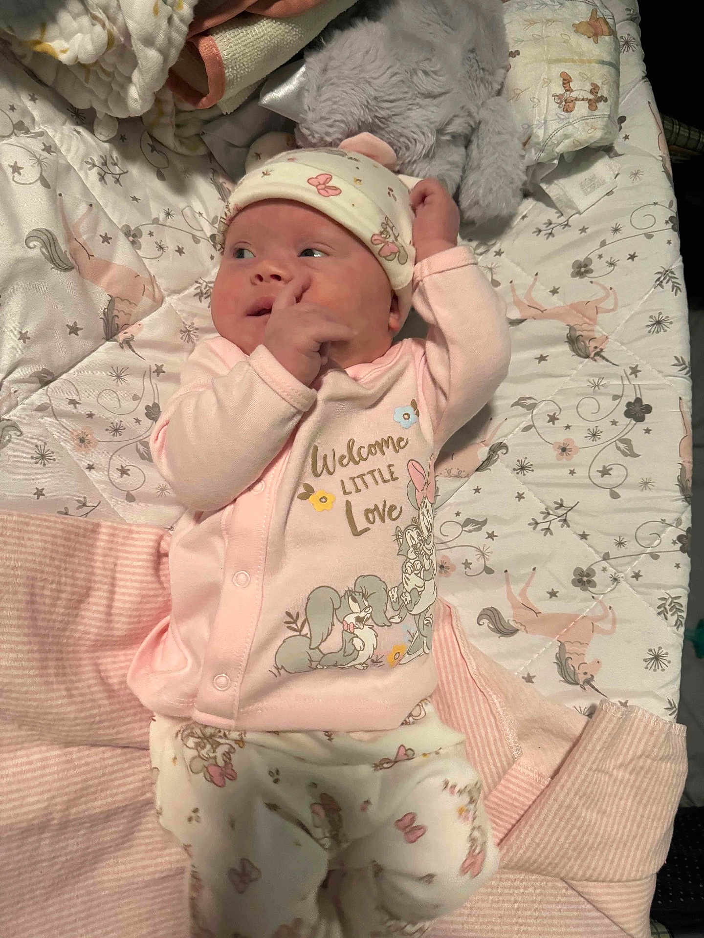 Ryleigh joined the competition — help win amazing prizes! baby, infant, pajamas, blanket, stuffed_animal, unicorn, floral_pattern, pink, cute, sleepwear, bed, lying_down, newborn, soft_toys, child, face, hand, headwear, cute_expression, cozy