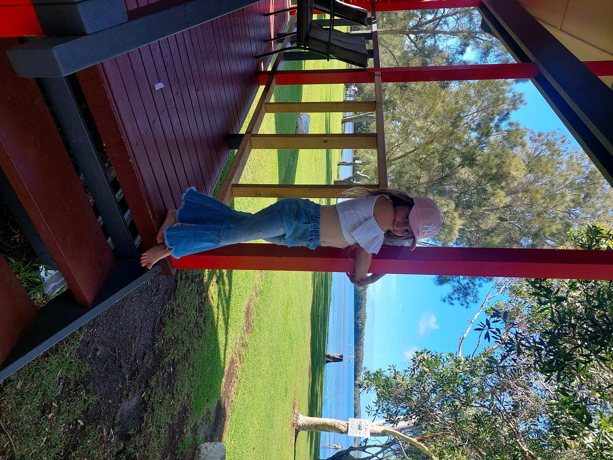 Sophie joined the competition — help win amazing prizes! daylighting, facade, fun, headwear, ladder, leisure, light, line, person, pole, red, shade, sky, tints_and_shades, tree, wood