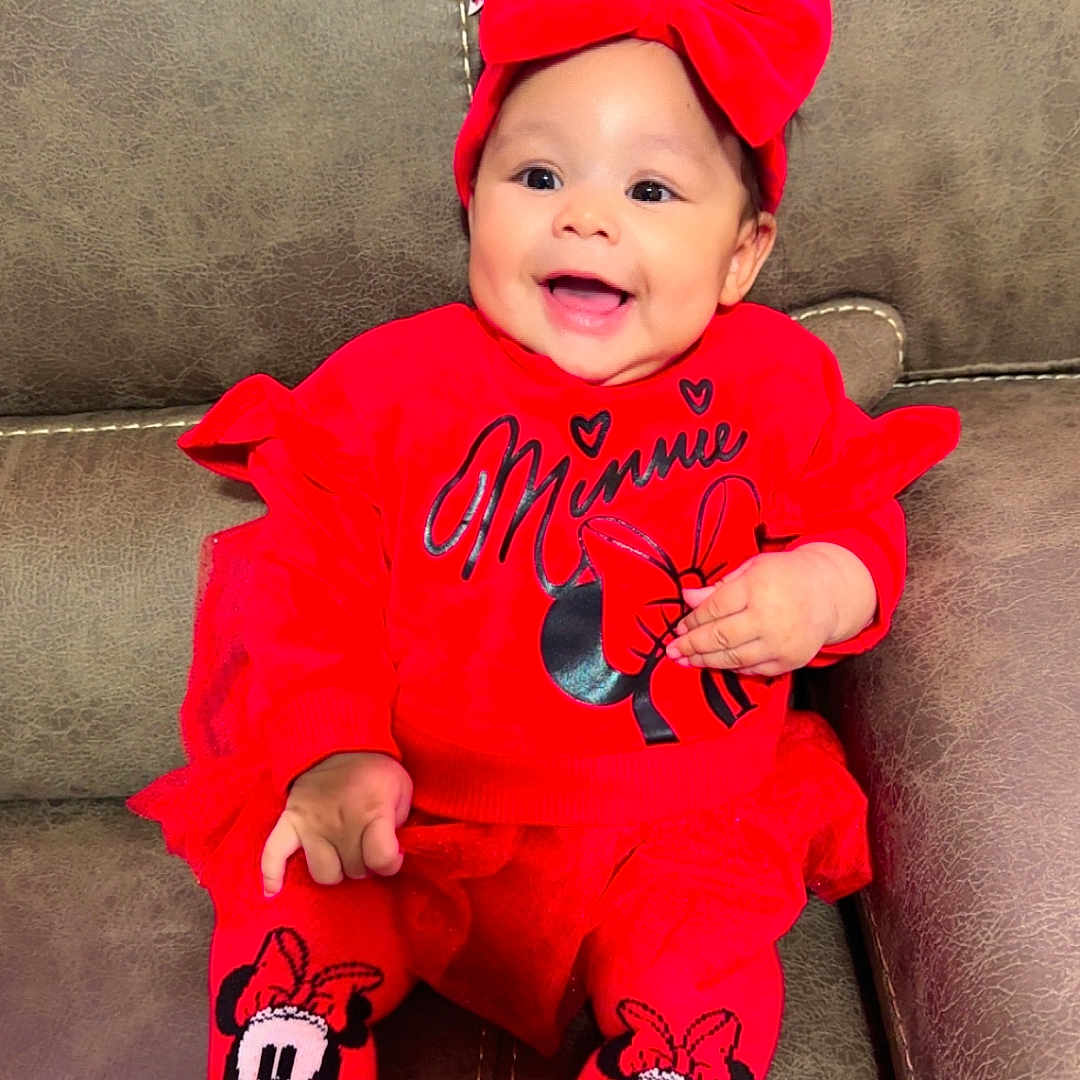 Jasmine is registered to the contest to win money with this photo: baby, bodypart, cap, clothing, couch, cushion, face, finger, furniture, glove, hand, hat, head, homedecor, hosiery, pants, person, photography, portrait, sock