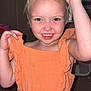child, smiling, orange_dress, sunglasses, indoor, portrait, happy, blonde_hair, cute, playful, face, person, fashion, young_child, ruffled_sleeves, room, toy, background, animal_image, fun