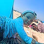 Lucy a rejoint le concours — aidez-le/la à gagner de superbes lots ! beach, blue_sky, cap, child, clothing, foot, holiday, mat, outdoor, pattern, people, playful, relaxation, sand, smiling, summer, sunlight, sunshade, toddler, vacation