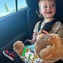 car_interior, car_seat, car_trip, casual, child, clothing, cute, daylight, happy, playful, rosy_cheeks, seatbelt, smiling, sneakers, stuffed_animal, teddy_bear, toddler, toy, window, young_child