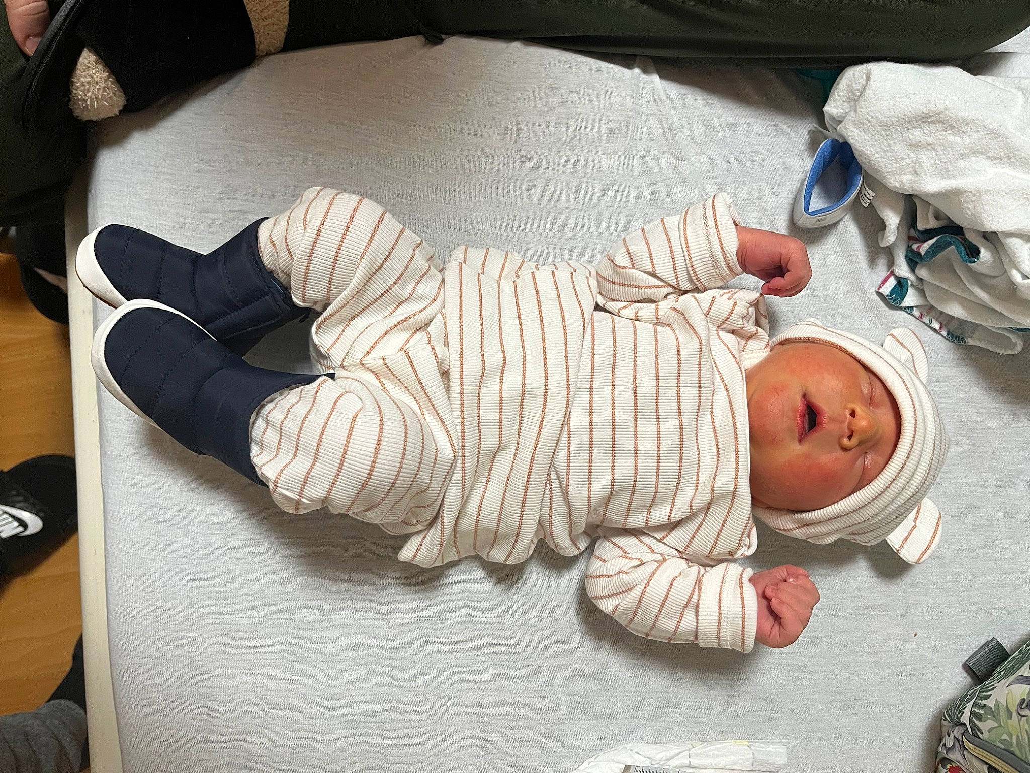 Coleson is registered to the contest to win money with this photo: baby, baby_products, baby_toddler_clothing, child, comfort, flooring, foot, hardwood, hat, headwear, human_leg, knee, nap, person, product, room, sitting, sleep, sock, thumb