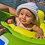 baby, beach, child, closeup, float, fun, happy, holiday, inflatable_ring, necklace, outdoor, palm_trees, people, summer, sun_hat, sunlight, swimming, toddler, vacation, water