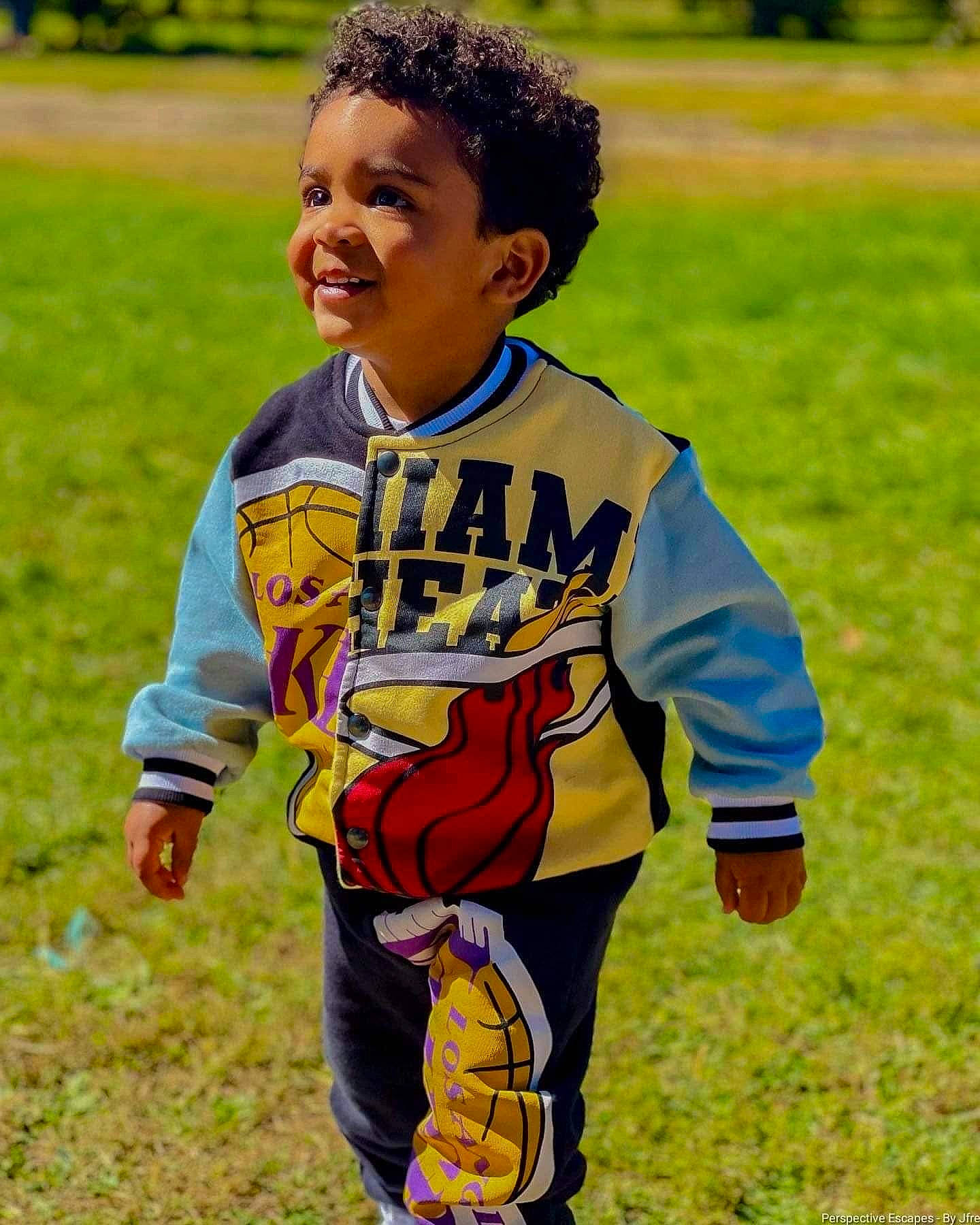 Kobe is registered to the contest to win money with this photo: child, competition_event, eye, face, fun, grass, grassland, happy, leisure, people_in_nature, person, play, player, recreation, sitting, sleeve, smile, soil, t_shirt, toddler