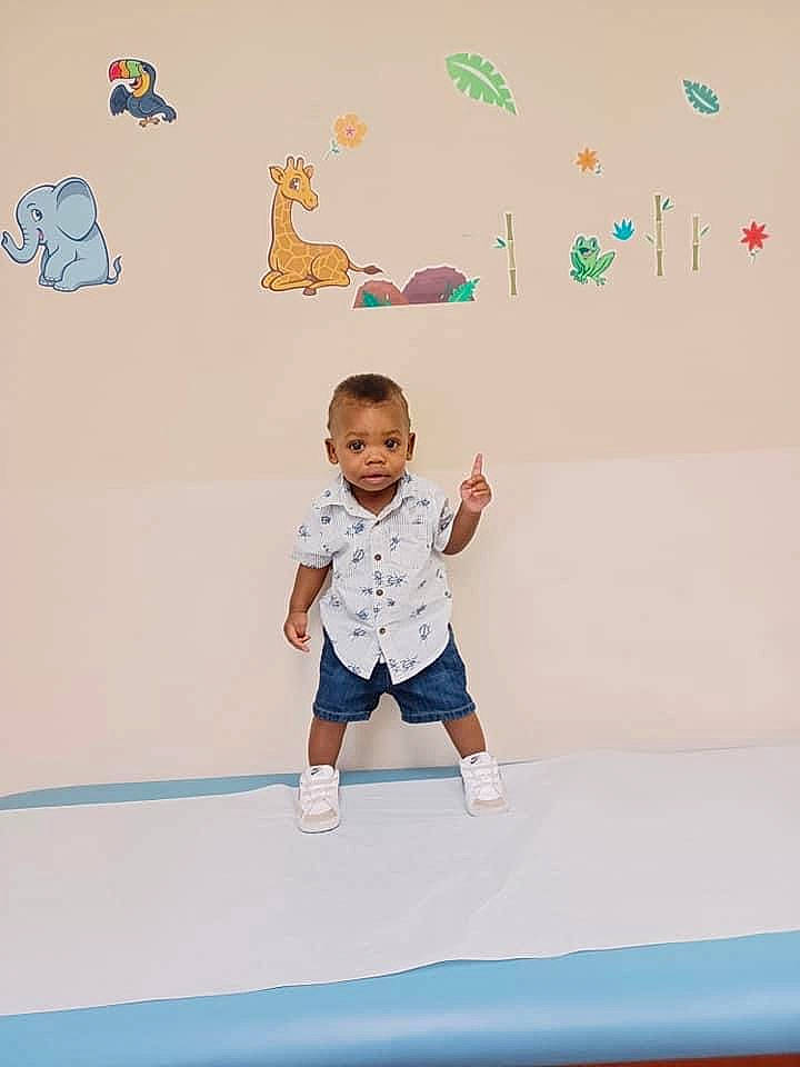 Eli is registered to the contest to win money with this photo: art, azure, baby, baby_toddler_clothing, barefoot, child, electric_blue, flooring, fun, gesture, happy, leisure, person, play, room, shorts, sleeve, t_shirt, toddler, visual_arts
