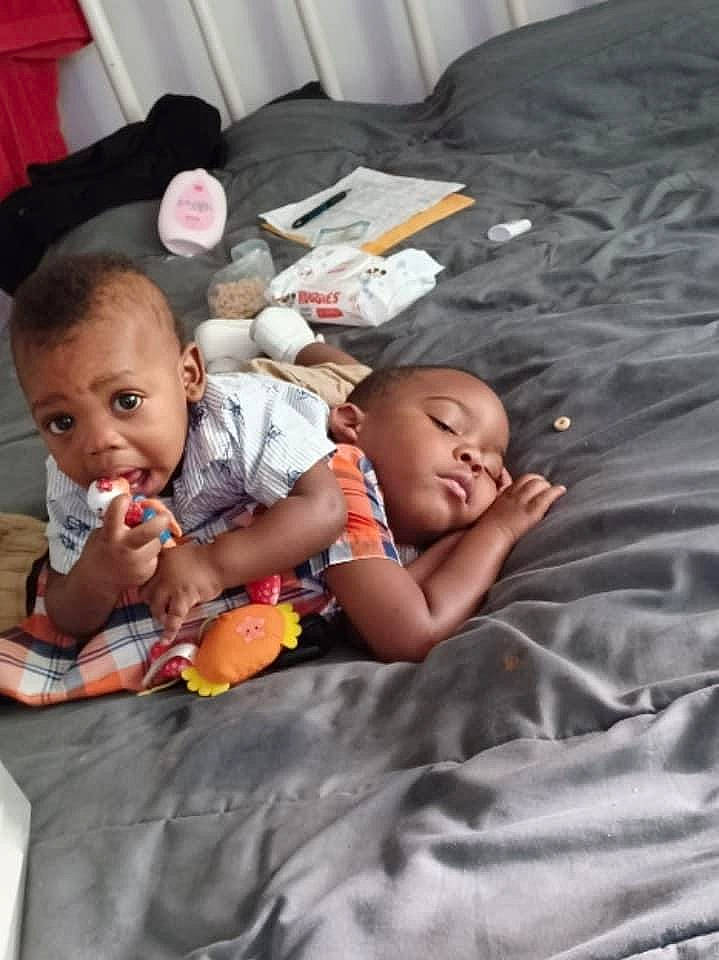 Eli is registered to the contest to win money with this photo: baby, baby_products, baby_toddler_clothing, bedding, bedtime, cheek, child, comfort, face, flooring, fun, happy, head, linens, people, person, play, room, sitting, skin