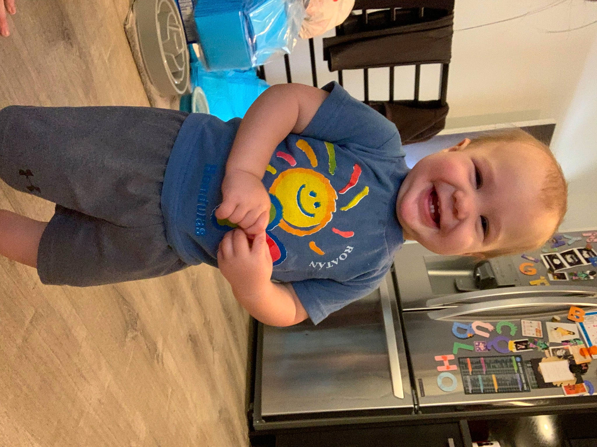 Malcolm is registered to the contest to win money with this photo: baby, child, elbow, electric_blue, finger, flooring, fun, human_leg, joint, joy, knee, leisure, machine, person, recreation, room, smile, sportswear, t_shirt, thigh