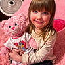 Presley is registered to the contest to win money with this photo: child, teddy_bear, pink, toy, smile, blue_eyes, long_hair, bedroom, blanket, fan, curtains, soft_texture, cute, happy, person, sitting, indoor, plush, clothing, portrait